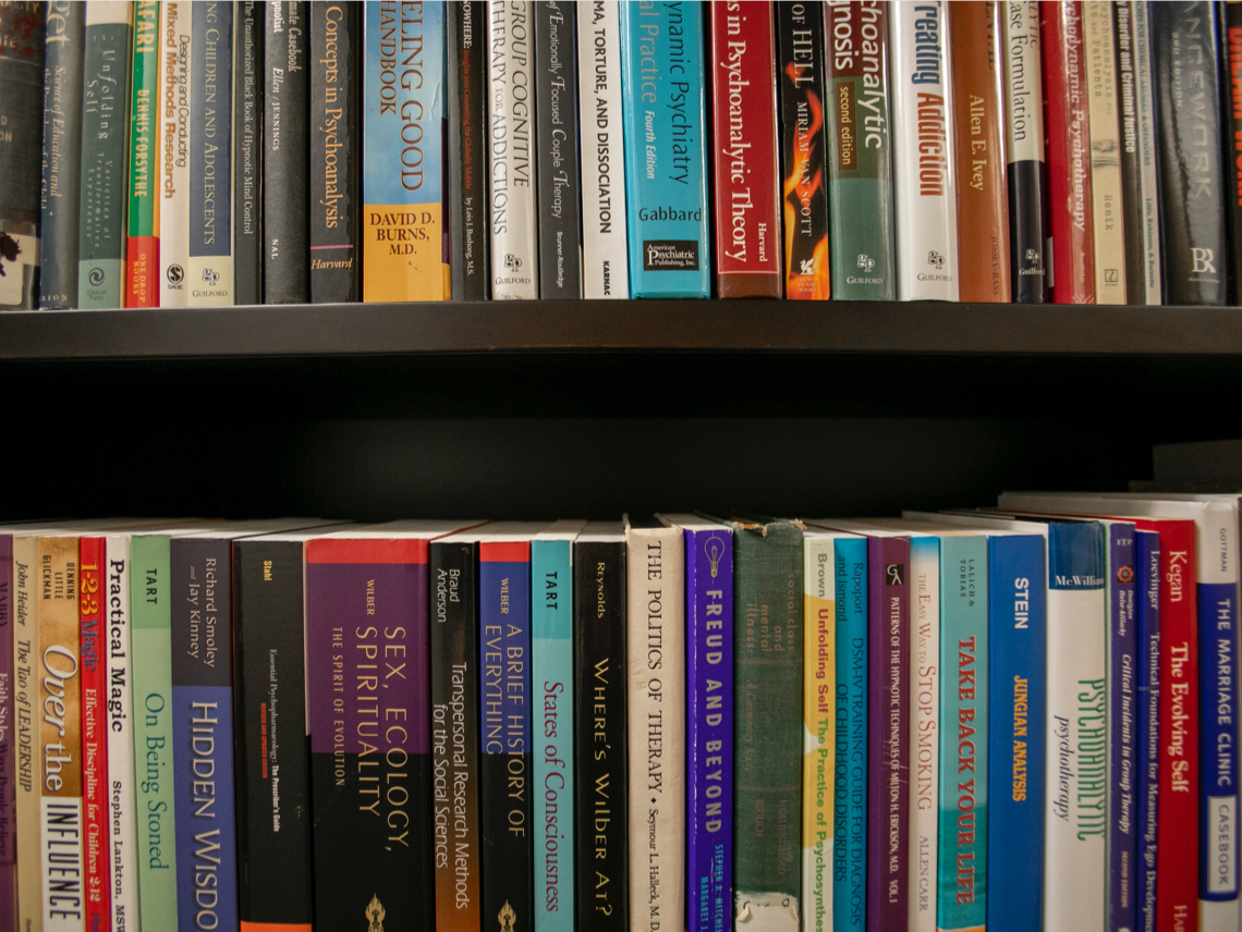 Our Mission | Bookshelf in a session room | Wellspring Psychology